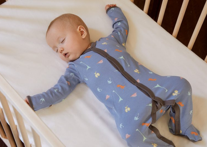 Baby lying in a cot