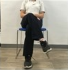 A person sitting on a chair with their legs crossed