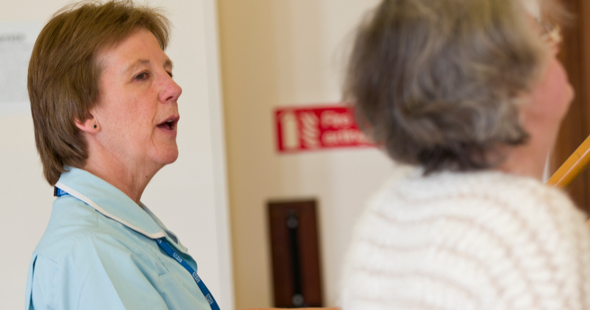 Physio Standing Next To Patient